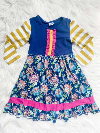Long sleeve dress for girls features stripes on the sleeves, floral, skirt and ruffle elements.