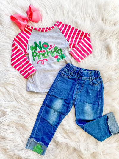 Adorable girls two piece St. Patricks day outfit! denim set with a long striped sleeve raglan that says no pinching on the front and cuffed denim jeans with shamrocks. 