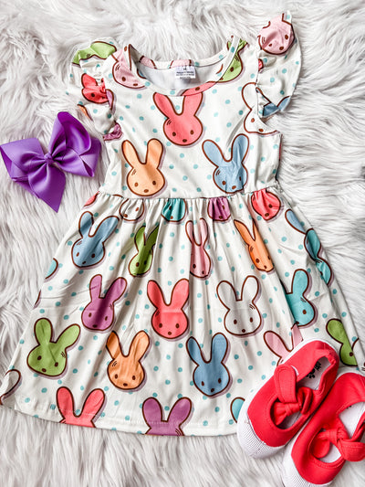 Girls pearl dress with multi-colored bunny heads and blue polka dots.