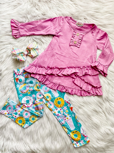 Two piece girls set with pink ruffle long sleeve top and teal leggings with donuts and milkshakes. 