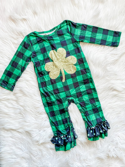 Kids black and green plaid romper with gold clover and ruffles at the ankles. 