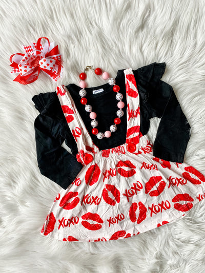Girls two piece skirt set with suspenders. Includes black long sleeve shirt and white skirt with red lips and xoxos. GIrls Valentine's Day outfit