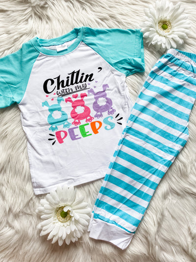 Unisex kids pajamas with blue and white striped bottoms and a raglan shirt with teal sleeves that says Chillin with my peeps.