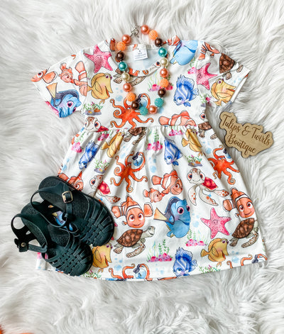 girls white short sleeve dress with all over watercolor sea friends print dress. mermaid inspired dress from orlando girls boutique. 