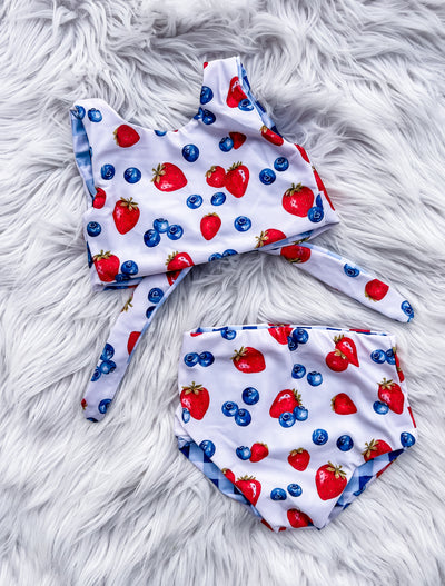 Girls Reversible two piece bathing suit. Adorable berry fruits design on one side, blue gingham on the other. 