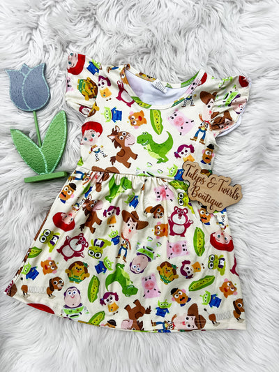 Adorable flutter sleeve dress for girls with an all over print of Andy and his closest toy friends