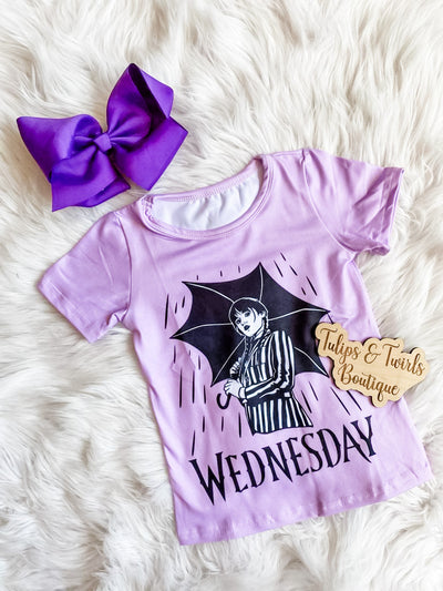 Girls Wednesday Dress with graphic print of Wednesday on front. Short sleeve purple Wednesday dress.