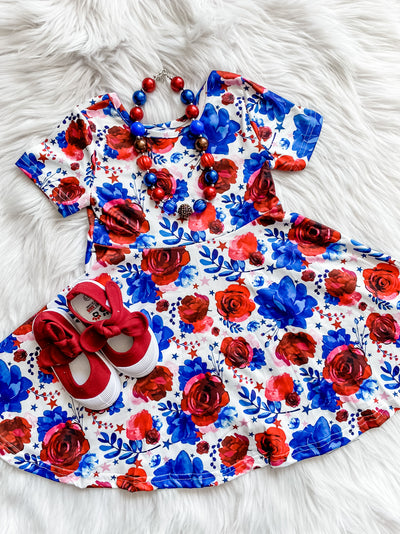Girls twirl dress with red and blue Americana style flowers. 