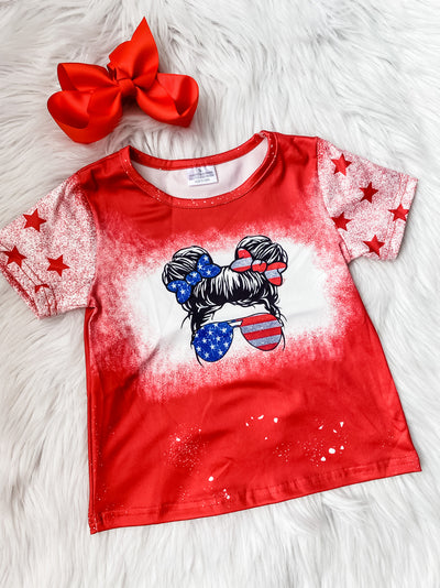 Girls red Patriotic t-shirt with American Flag sunglasses and hair bows printed on the front and spray paint star sleeves. 