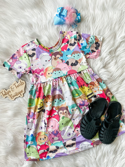 Girls short sleeve pearl dress with squishy characters. 