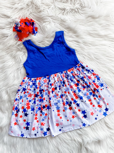 Girls sleeveless dress with blue top and red and blue falling stars along the skirt. 