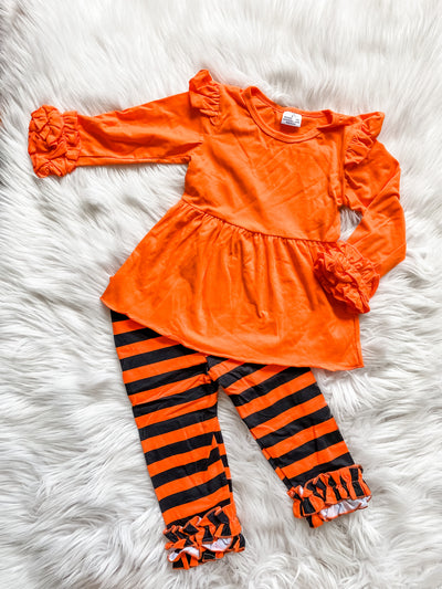 Girls two piece orange and black legging set with icing sleeves. 