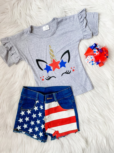Girls two piece outfit with a grey ruffle shirt with unicorn on the front and denim shorts with American stars and stripes on it. 