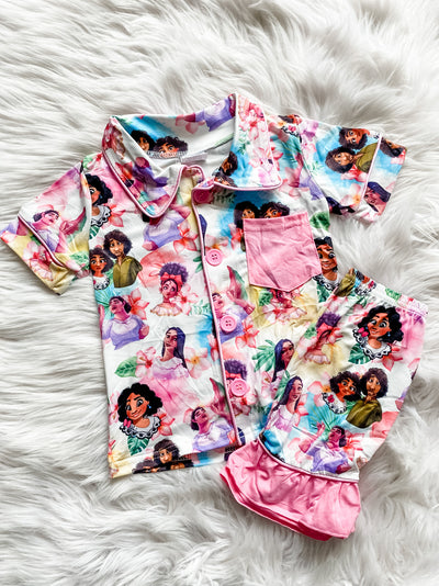 Girls two piece pink pajama set with shorts and button up top with Madrigal family print. 