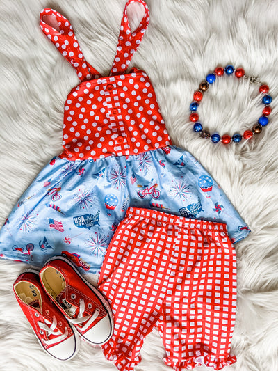 Fourth of July themed set with red and white polka dots and ruffle red and white plaid shorts and a tunic tank top with red and white polka dots and light blue with fireworks pattern.