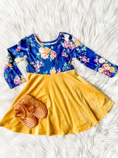 Girls long sleeve twirl dress with blue top and floral print and yellow velvet skirt. 