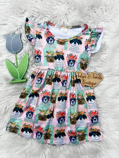 Adorable girls flutter sleeve dress with sweet pictures of dogs with floral crowns.