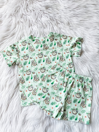 Kids unisex green pajamas with sloth print. Short sleeve short and shorts set. 