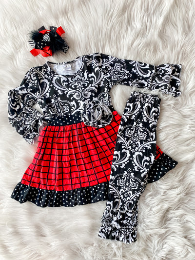 Girls two piece ruffle set with black and white damask print with plaid skirt and rosette on hip and matching damask leggings. 