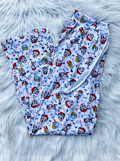 White drawstring Men's lounge pants with magical duck, mouse, and dog characters in Santa hats and Christmas lights. 