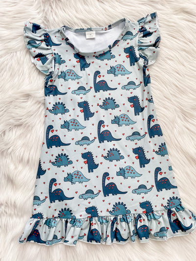 Girls nightgown with short flutter sleeves and a flutter hem with different blue dinosaurs with red hearts. 