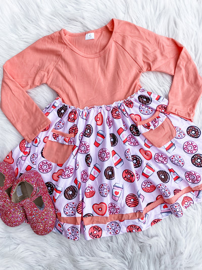 Girls long sleeve twirl dress with peach top and big twirl skirt with donuts, coffee, hearts, and peach pockets. 
