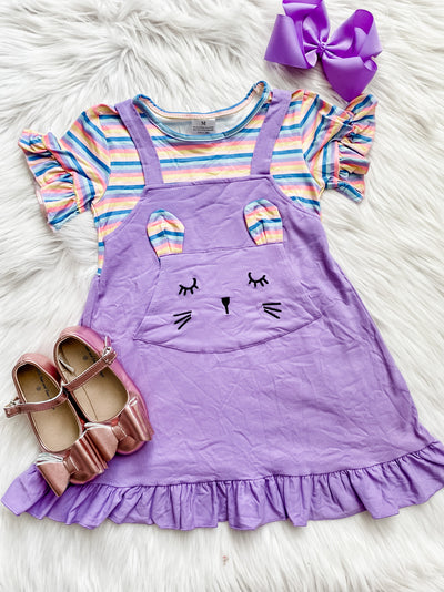 Girls purple dress with a bunny pocket on the front and colorful striped sleeves. 