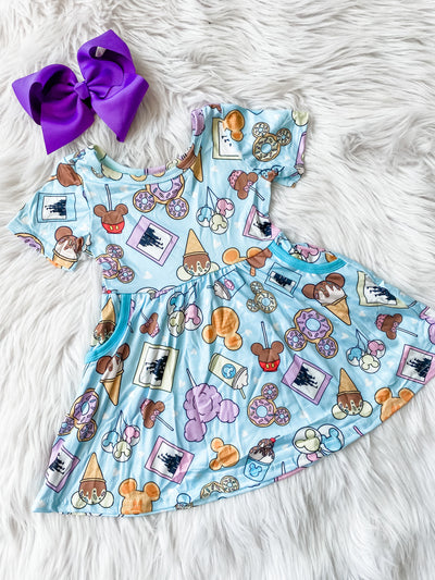 Girls short sleeve dress with blue background and mouse shaped sweet treats and pockets on the side. theme park treats