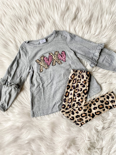 Adorable girls Valentine's Day outfit set with cheetah print leggings, grey long sleeve top with pink and brown xoxo cheetah print on shirt. 