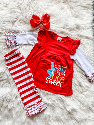 Two piece girls set includes red and white striped pants with ruffles and long sleeve red and white ruffle shirt that says "Jesus makes life sweet."