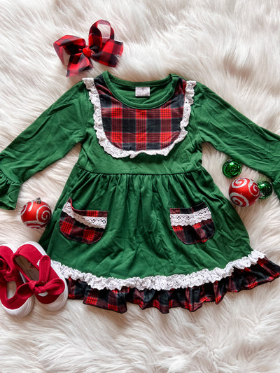 Girls green holiday dress with tartan plaid pockets and ruffle hem.
