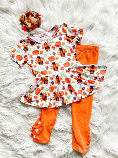Girls Thanksgiving Outfit with orange leggings and short sleeve peplum top. Adorable thanksgiving print.