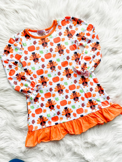 Thanksgiving nightgown for girls with long ruffle sleeves, and orange ruffle along the bottom with turkeys, pumpkins, and leaves printed on it