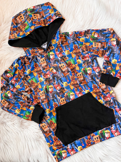 Unisex long sleeve kids hoodie featuring popular online block game characters with a black front pocket. 