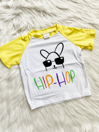 Unisex raglan kids shirt with yellow sleeves and a bunny wearing sunglass and the words Hip-Hop written in different colors. 